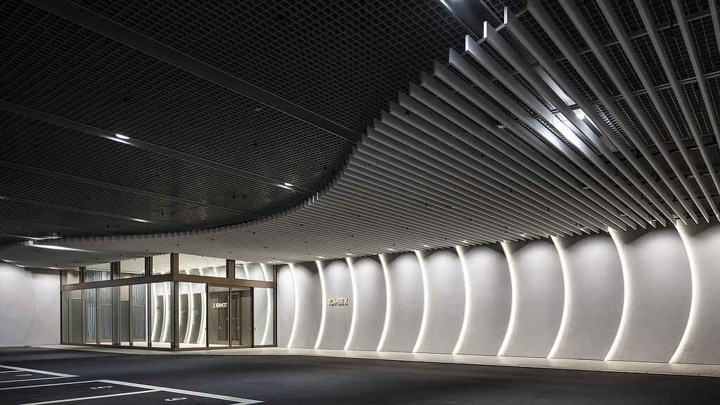 A large white building with a large glass ceiling.